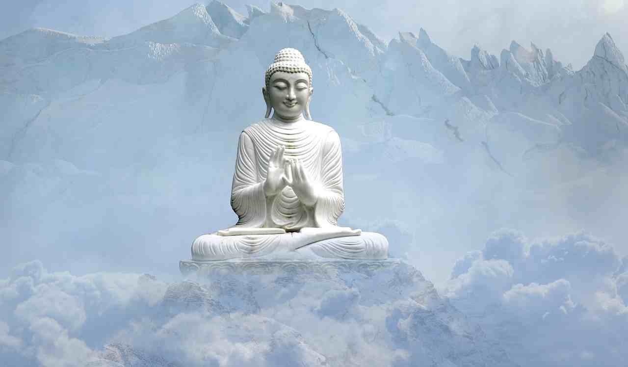 Buddhafigur sitzt auf einem Felsen im Himmel - Saturn in den Fischen