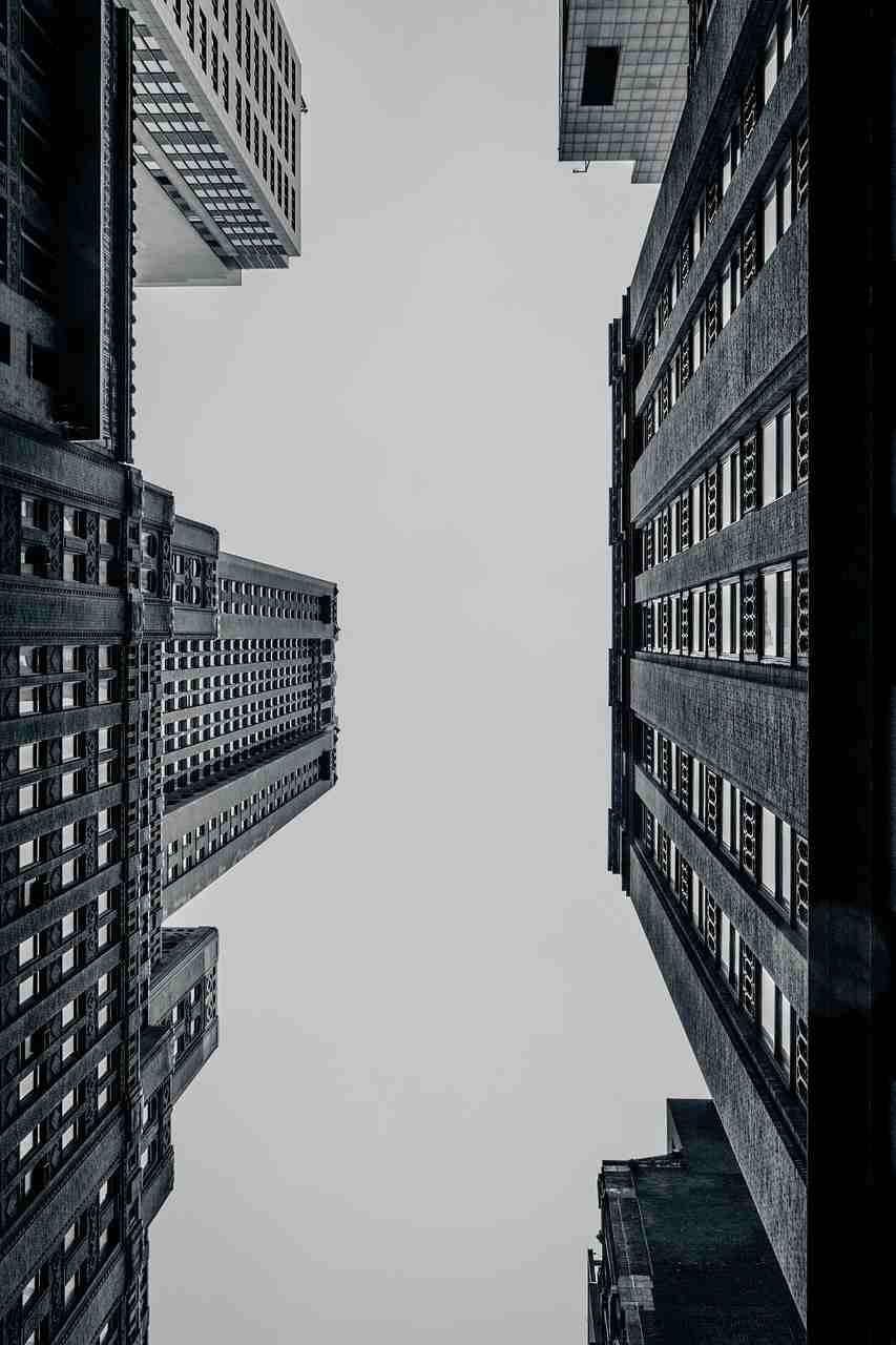 quadratische Bauten von unten fotografiert in schwarz-weiß - Erdzeitalter/ Erdepoche